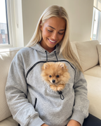 Woman in a light gray Pawdie Pocket Hoodie with a Pomeranian
